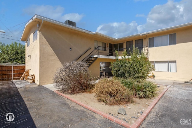 exterior space featuring fence and stairs