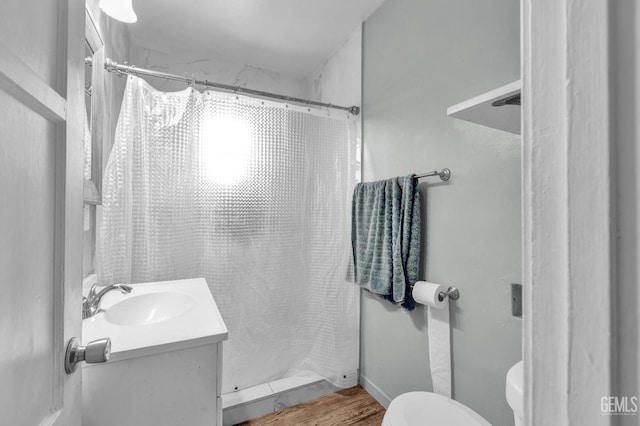 1504 Stockton Ave, Bakersfield, CA 93308 - bathroom with vanity, a shower with curtain, and wood finished floors