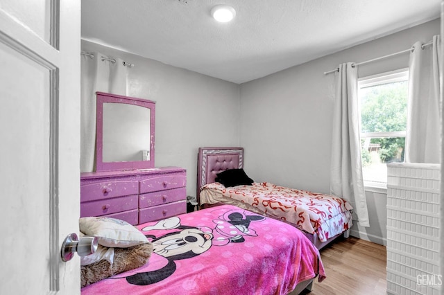 1504 Stockton Ave, Bakersfield, CA 93308 - bedroom featuring wood finished floors and a textured ceiling
