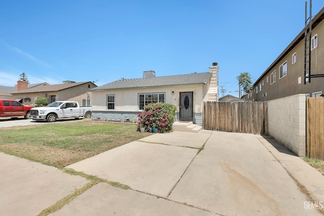 1504 Stockton Ave, Bakersfield, CA 93308 - bungalow-style home with stucco siding and a chimney