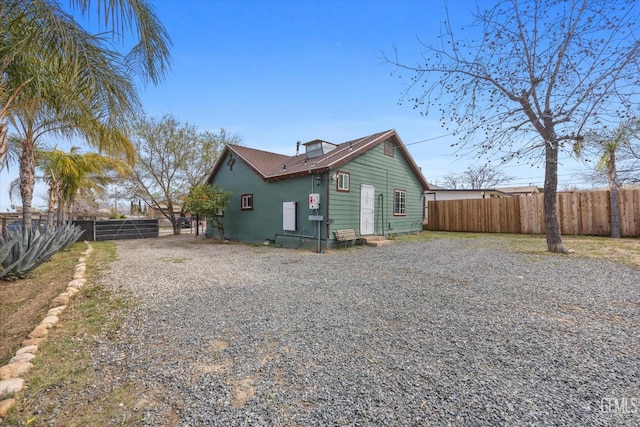 rear view of house featuring fence private yard