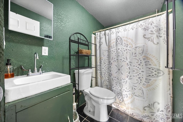 bathroom with a textured ceiling, a textured wall, tile patterned flooring, toilet, and vanity