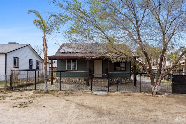 bungalow-style house with covered porch, a fenced front yard, and a gate