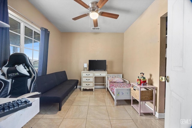 bedroom with visible vents, ceiling fan, baseboards, and light tile patterned floors