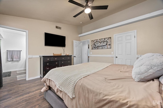 bedroom featuring a ceiling fan, visible vents, vaulted ceiling, baseboards, and dark wood finished floors