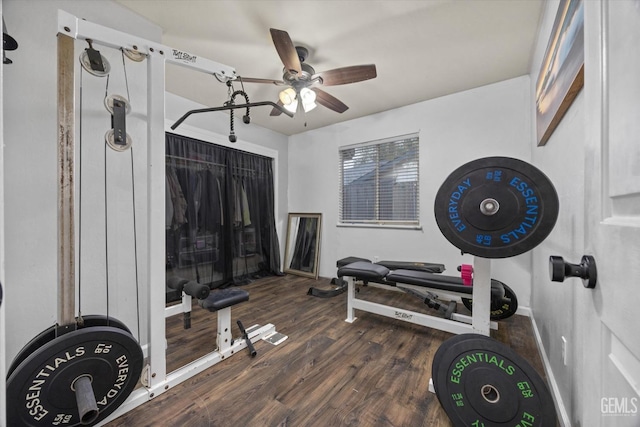 workout room with ceiling fan, baseboards, and wood finished floors