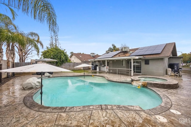 view of pool featuring a pool with connected hot tub, a fenced backyard, a patio, and central AC