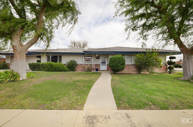 ranch-style home with stucco siding, a tile roof, a front lawn, and brick siding