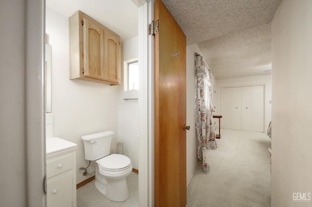 full bath featuring toilet, baseboards, a textured ceiling, and vanity