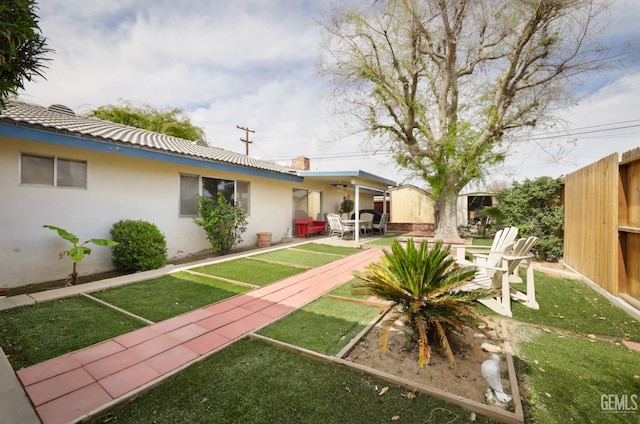 view of yard with fence and a patio