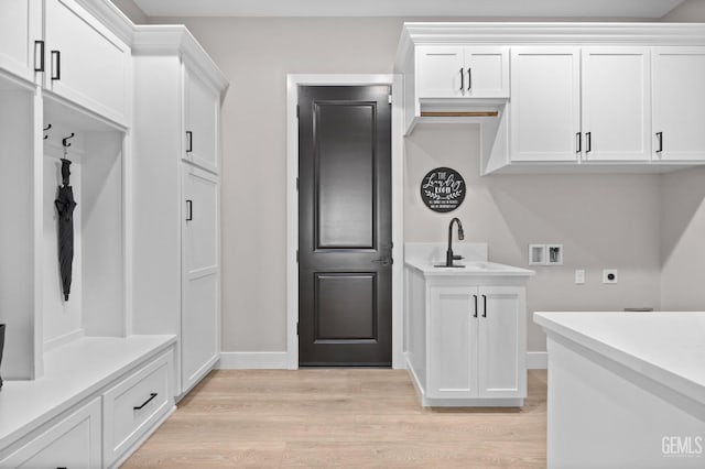 interior space with sink and light hardwood / wood-style flooring