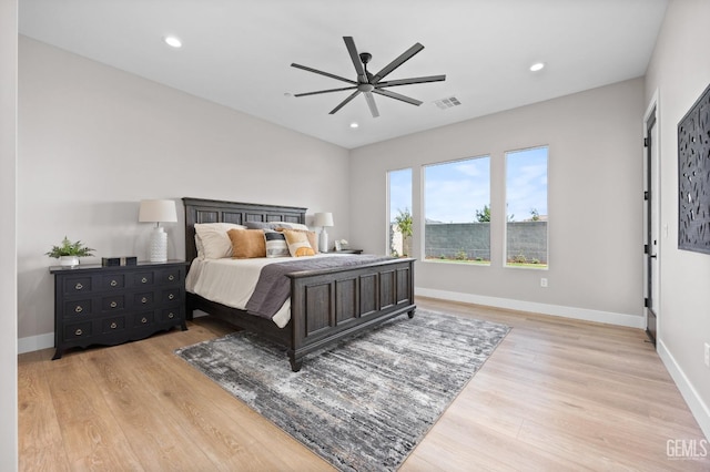 bedroom with ceiling fan and light hardwood / wood-style floors