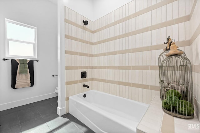 bathroom featuring tile patterned flooring, toilet, and washtub / shower combination