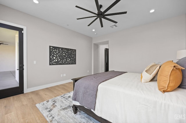 bedroom with light hardwood / wood-style floors and ceiling fan