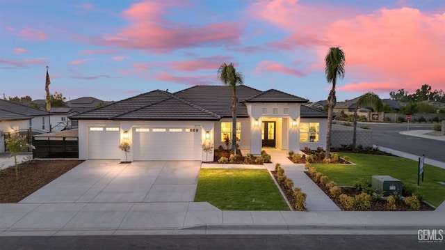 view of front facade featuring a lawn and a garage