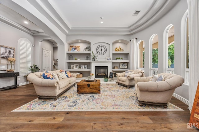 1001 Paxton Way, Bakersfield, CA 93312 - living area with built in features, healthy amount of natural light, wood finished floors, arched walkways, and recessed lighting