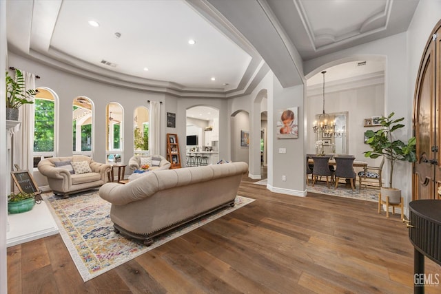 1001 Paxton Way, Bakersfield, CA 93312 - living room with arched walkways, hardwood / wood-style floors, a tray ceiling, a chandelier, and recessed lighting