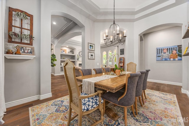 1001 Paxton Way, Bakersfield, CA 93312 - dining room with a chandelier, wood finished floors, arched walkways, and built in features