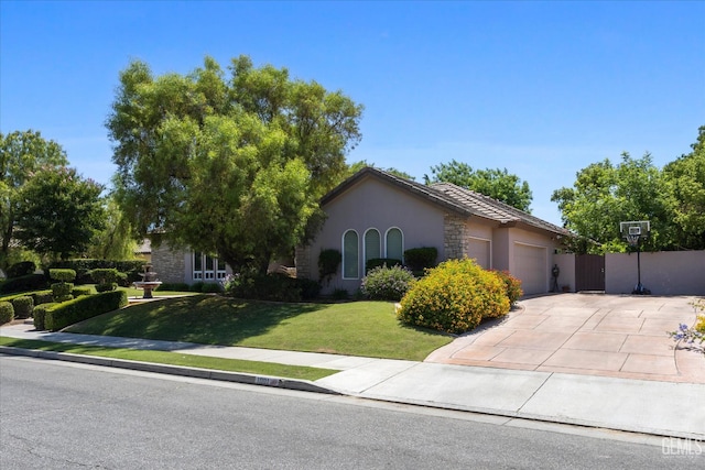 1001 Paxton Way, Bakersfield, CA 93312 - view of property hidden behind natural elements featuring an attached garage, a front yard, stucco siding, and concrete driveway