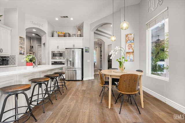 1001 Paxton Way, Bakersfield, CA 93312 - dining room with arched walkways, light wood-type flooring, and recessed lighting