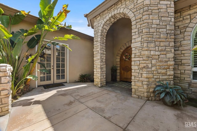 1001 Paxton Way, Bakersfield, CA 93312 - view of exterior entry featuring french doors, stone siding, a patio area, and stucco siding
