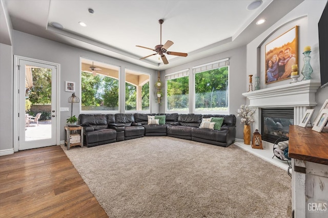 1001 Paxton Way, Bakersfield, CA 93312 - living room with a raised ceiling, a ceiling fan, a glass covered fireplace, wood finished floors, and recessed lighting
