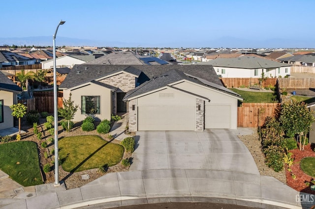 ranch-style home featuring an attached garage, fence, a residential view, and driveway