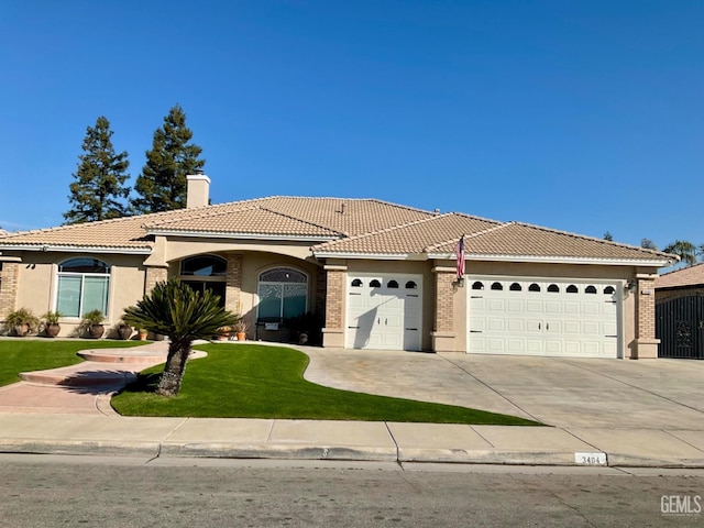 view of front of house featuring a tiled roof, driveway, a chimney, and an attached garage