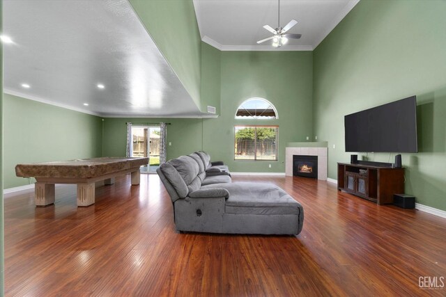 4312 Rio Viejo Dr, Bakersfield, CA 93313 - living area featuring billiards, a tiled fireplace, wood finished floors, and ornamental molding
