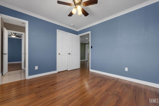 4312 Rio Viejo Dr, Bakersfield, CA 93313 - unfurnished bedroom with baseboards, ornamental molding, wood finished floors, and a closet