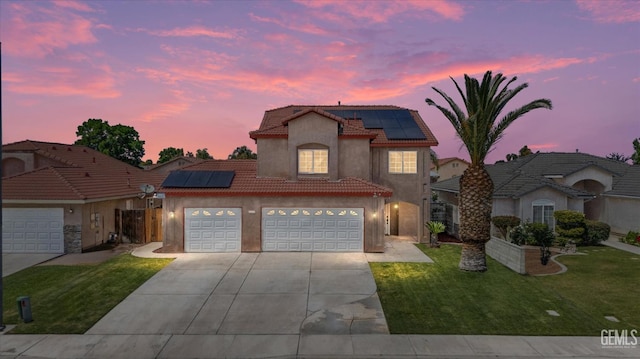 4312 Rio Viejo Dr, Bakersfield, CA 93313 - view of front of property with a tile roof, solar panels, concrete driveway, a garage, and stucco siding