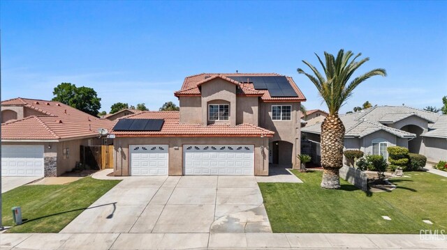 4312 Rio Viejo Dr, Bakersfield, CA 93313 - mediterranean / spanish-style house with concrete driveway, a tiled roof, roof mounted solar panels, an attached garage, and stucco siding