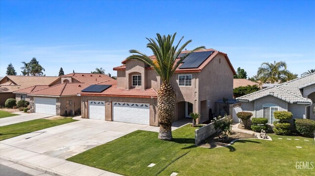 4312 Rio Viejo Dr, Bakersfield, CA 93313 - view of front of home with roof mounted solar panels, stucco siding, a front yard, and a garage