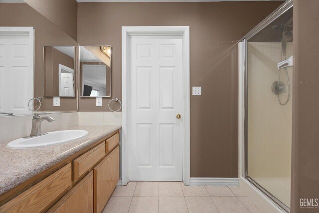 4312 Rio Viejo Dr, Bakersfield, CA 93313 - bathroom featuring tile patterned floors, baseboards, vanity, and a shower stall