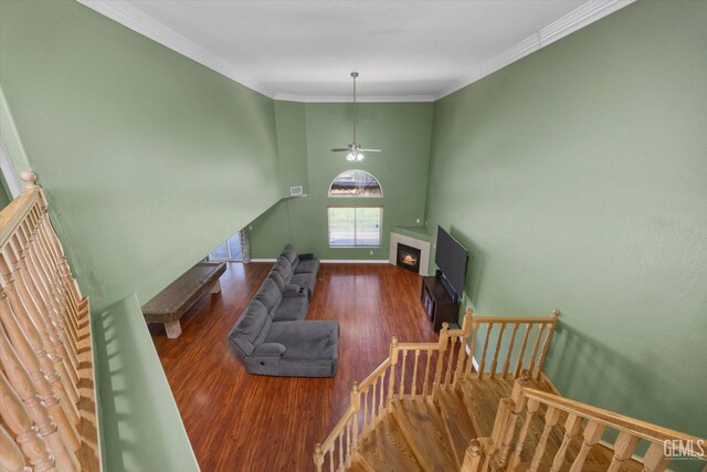 4312 Rio Viejo Dr, Bakersfield, CA 93313 - living room with baseboards, a ceiling fan, wood finished floors, a warm lit fireplace, and stairway