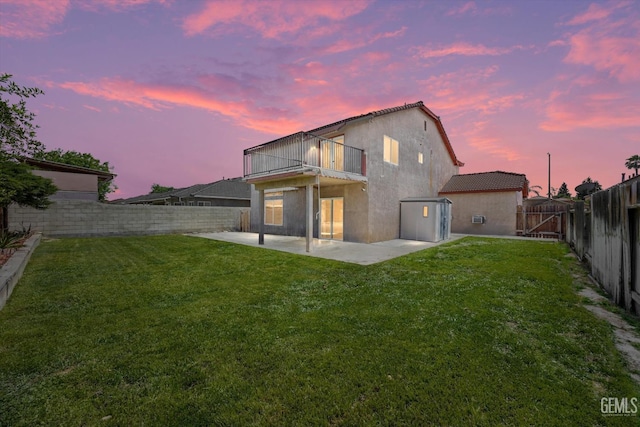 4312 Rio Viejo Dr, Bakersfield, CA 93313 - back of property featuring a patio area, a balcony, a lawn, a fenced backyard, and stucco siding