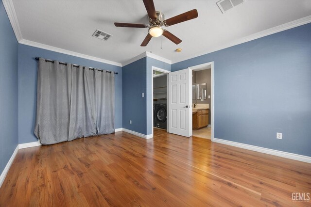 4312 Rio Viejo Dr, Bakersfield, CA 93313 - unfurnished bedroom with baseboards, wood finished floors, visible vents, and washer / clothes dryer