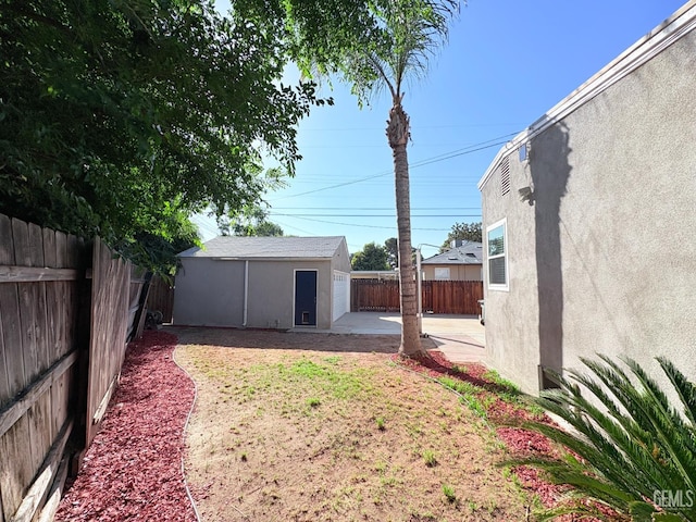 2711 Hubbard St, Bakersfield, CA 93301 - fenced backyard featuring an outdoor structure and a patio area