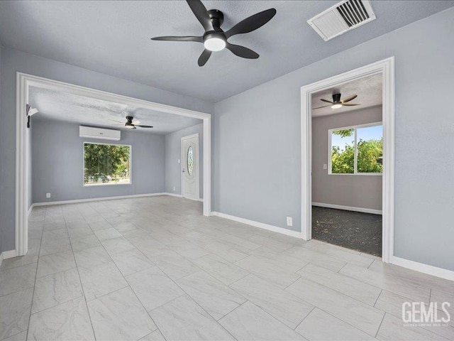 801 Fillmore St, Taft, CA 93268 - unfurnished room with a ceiling fan, a wall mounted air conditioner, and a textured ceiling