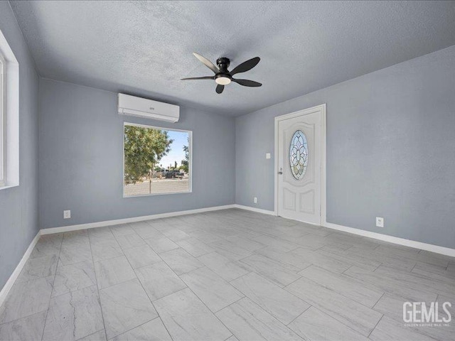 801 Fillmore St, Taft, CA 93268 - empty room featuring a wall mounted air conditioner, a ceiling fan, and a textured ceiling