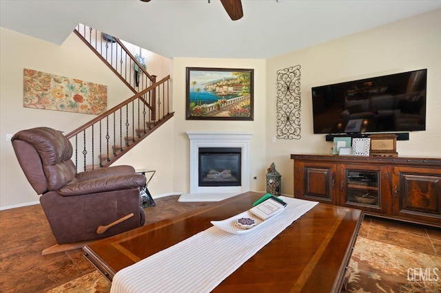 16018 La Strada Ct, Bakersfield, CA 93314 - living room featuring a ceiling fan, a glass covered fireplace, and stairway