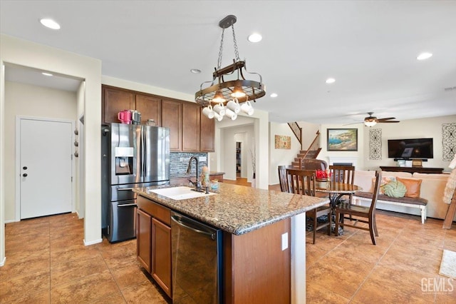 16018 La Strada Ct, Bakersfield, CA 93314 - kitchen with appliances with stainless steel finishes, decorative backsplash, a ceiling fan, open floor plan, and stone counters