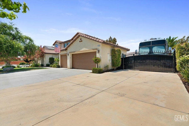 16018 La Strada Ct, Bakersfield, CA 93314 - mediterranean / spanish-style home featuring concrete driveway, stucco siding, a tile roof, a garage, and a gate