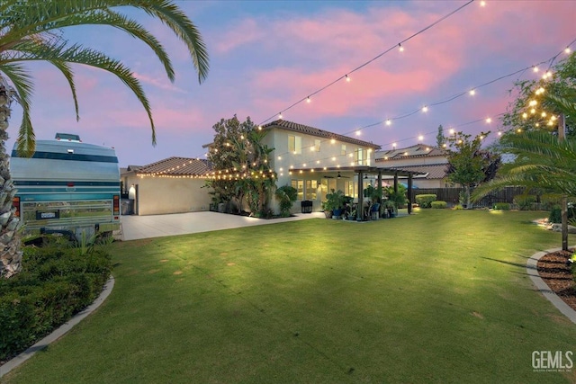 16018 La Strada Ct, Bakersfield, CA 93314 - view of front facade with a patio area, a fenced backyard, stucco siding, and a pergola