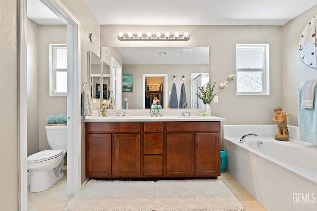 16018 La Strada Ct, Bakersfield, CA 93314 - bathroom featuring double vanity, a garden tub, and tile patterned floors