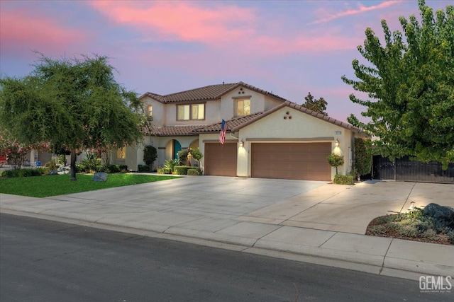 16018 La Strada Ct, Bakersfield, CA 93314 - mediterranean / spanish-style house with stucco siding, concrete driveway, a garage, and a tiled roof