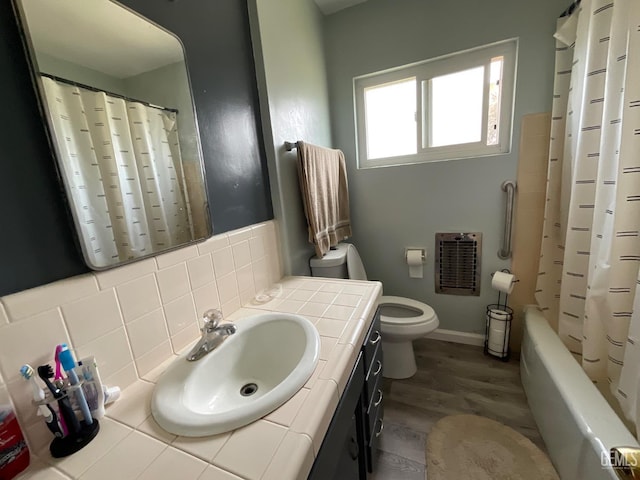 3914 Apache Ave, Bakersfield, CA 93309 - full bathroom featuring heating unit, vanity, tasteful backsplash, wood finished floors, and shower / bath combo