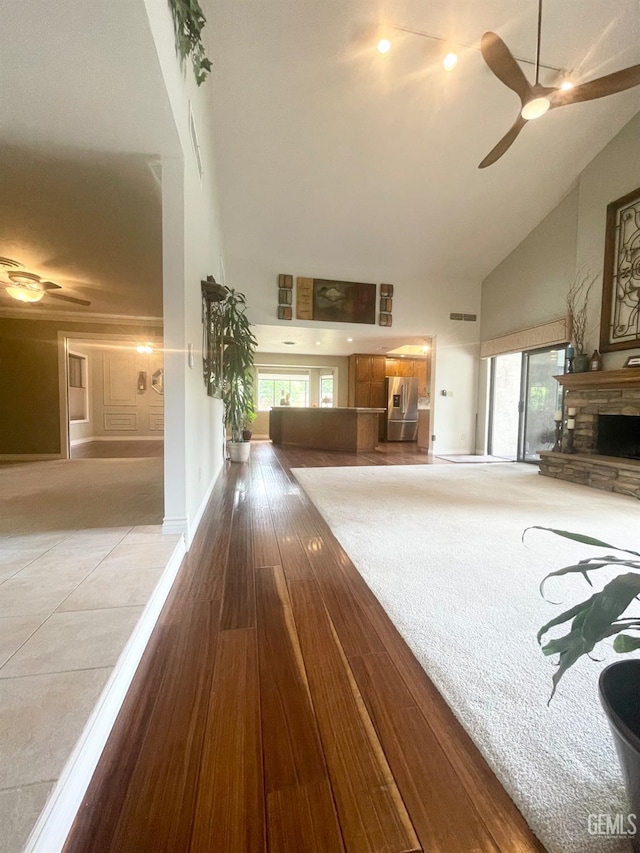 2204 Tilden Way, Bakersfield, CA 93309 - living room with high vaulted ceiling, ceiling fan, and a stone fireplace