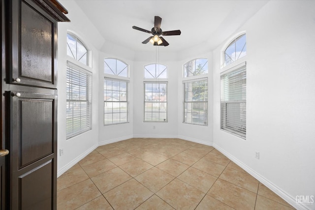 unfurnished sunroom with ceiling fan