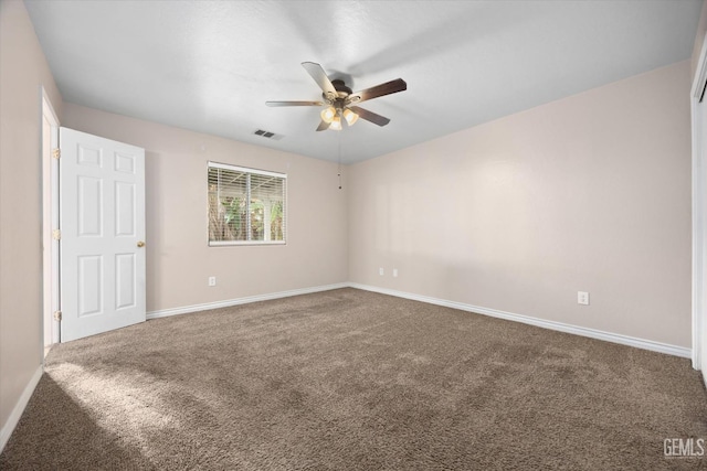 carpeted empty room featuring visible vents, ceiling fan, and baseboards